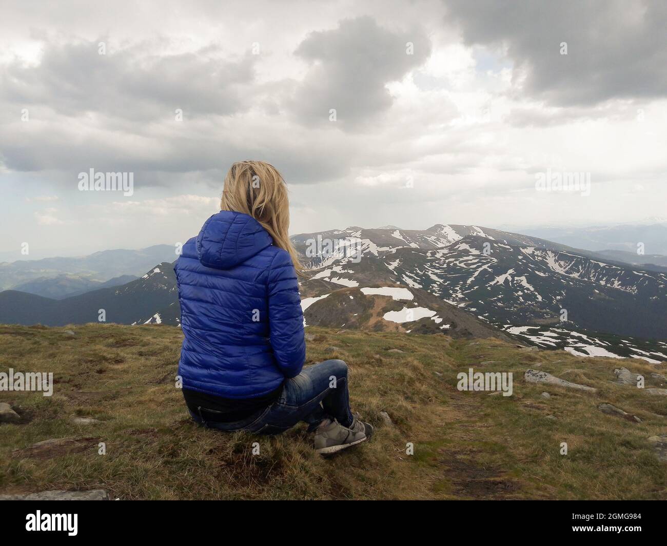 Girl sitting on high hill hi-res stock photography and images - Alamy