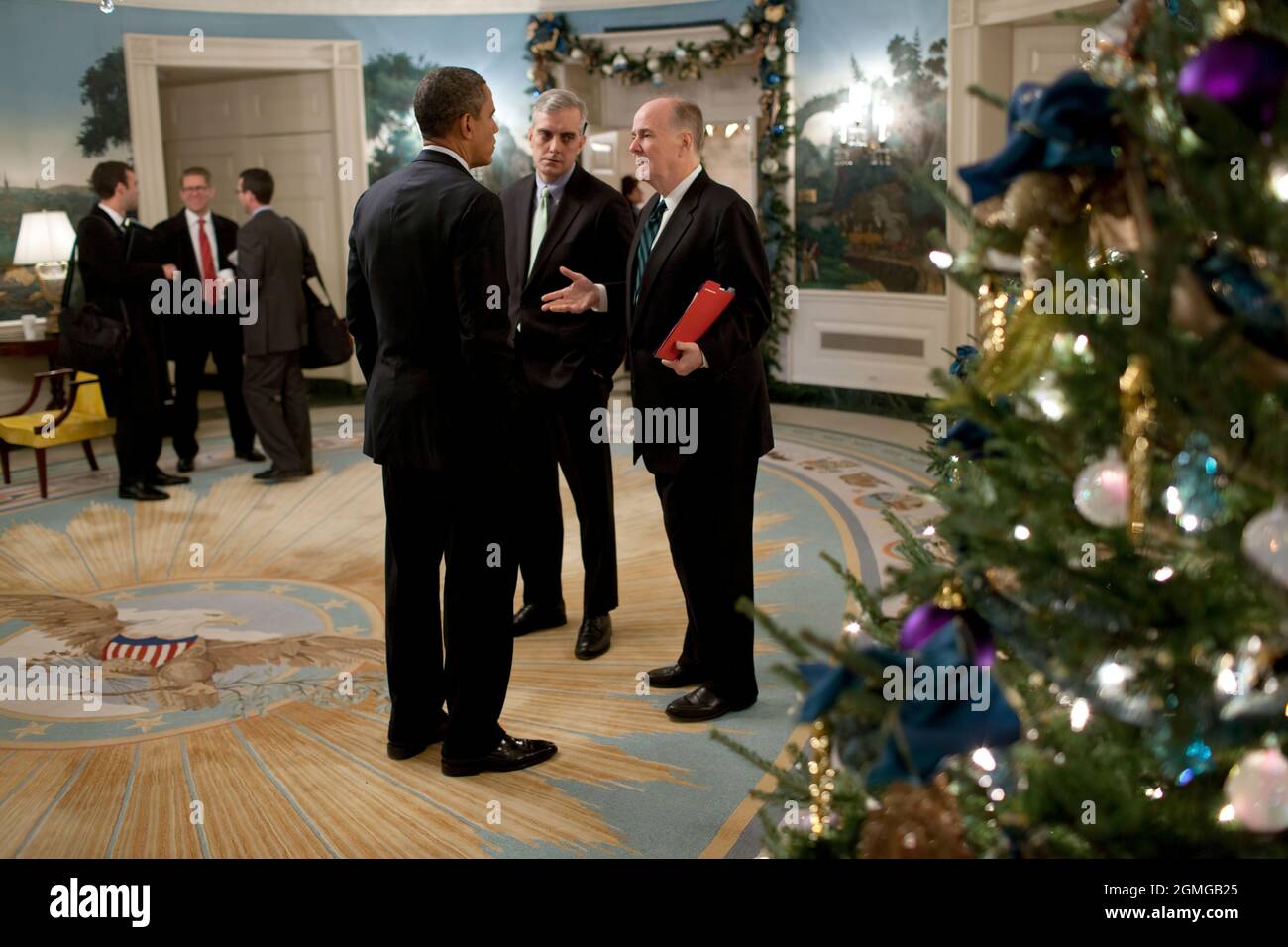 President Barack Obama talks with Deputy National Security Advisor Denis McDonough and National Security Advisor Tom Donilon in the Diplomatic Reception Room of the White House, before departing for Osawatomie, Kan., Dec. 6, 2011. (Official White House Photo by Pete Souza) This official White House photograph is being made available only for publication by news organizations and/or for personal use printing by the subject(s) of the photograph. The photograph may not be manipulated in any way and may not be used in commercial or political materials, advertisements, emails, products, promotions Stock Photo