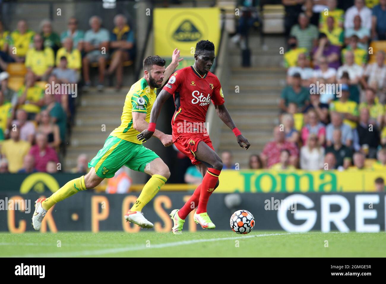 Norwich, UK. 18th Sep, 2021. Ismala Sarr of Watford gets ahead of Grant Hanley of Norwich City during the Premier League match between Norwich City and Watford at Carrow Road on September 18th 2021 in Norwich, England. (Photo by Mick Kearns/phcimages.com) Credit: PHC Images/Alamy Live News Stock Photo