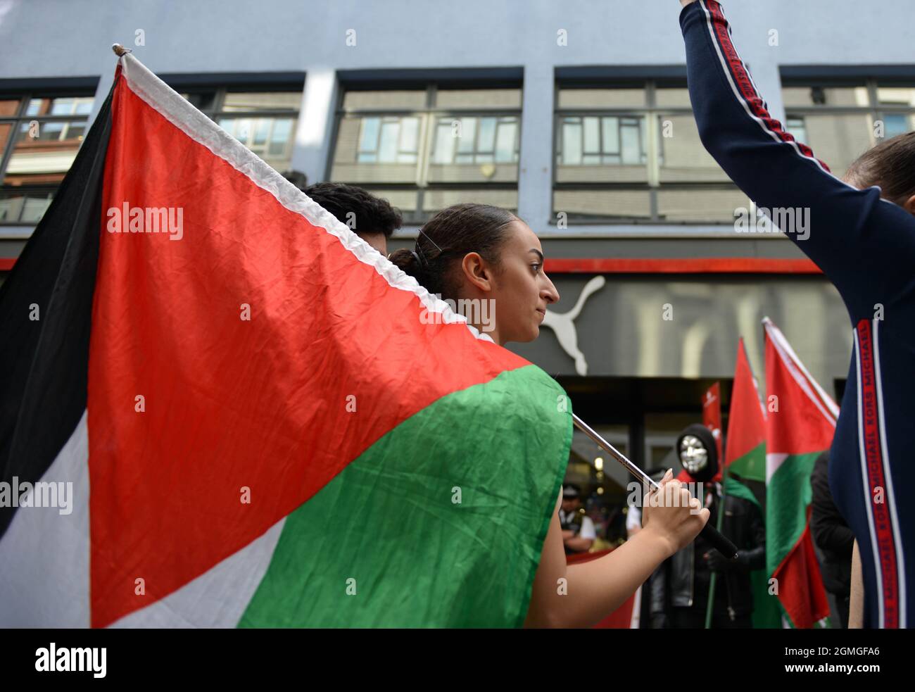 London, UK. 18th Sep, 2021. A protestor holding a Palestinian flag during the demonstration.Boycott Puma protest organised by Palestine Solidarity Campaign and FOA (Friends of Al Aqsa) at Puma flagship store on Carnaby Street, London. Activists demonstrated against Puma's sponsorship of the IFA (Israel Football Association). Credit: SOPA Images Limited/Alamy Live News Stock Photo