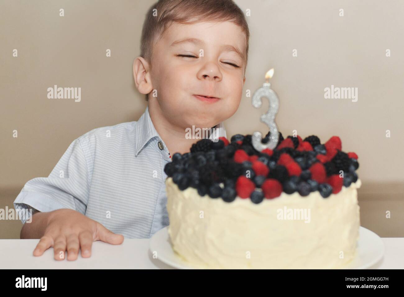 A boy blows out the candles for his birthday Stock Photo Alamy