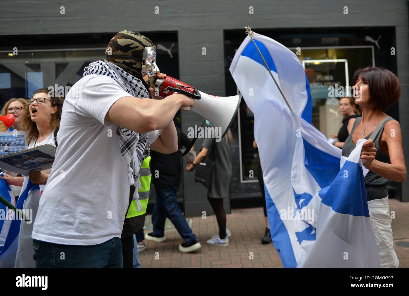 London, UK. 18th Sep, 2021. An activist with a megaphone confronts a counter protester with an Israeli flag during the demonstration.Boycott Puma protest organised by Palestine Solidarity Campaign and FOA (Friends of Al Aqsa) at Puma flagship store on Carnaby Street, London. Activists demonstrated against Puma's sponsorship of the IFA (Israel Football Association). (Photo by Thomas Krych/SOPA Images/Sipa USA) Credit: Sipa USA/Alamy Live News Stock Photo