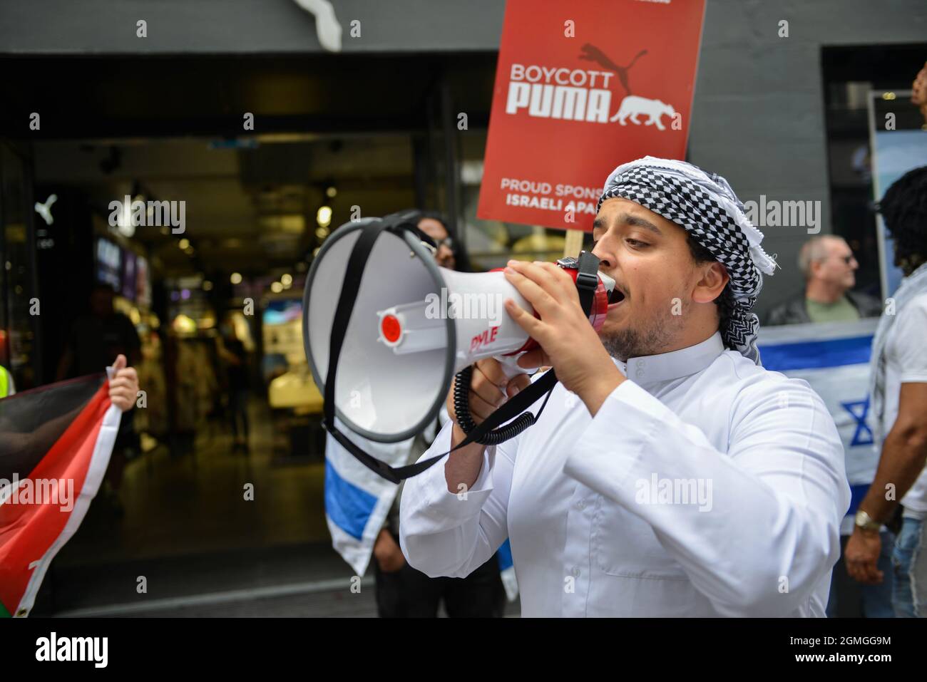 A protestor shouts through a megaphone, during the demonstration.Boycott Puma protest organised by Palestine Solidarity Campaign and FOA (Friends of Al Aqsa) at Puma flagship store on Carnaby Street, London. Activists demonstrated against Puma's sponsorship of the IFA (Israel Football Association). (Photo by Thomas Krych / SOPA Images/Sipa USA) Stock Photo