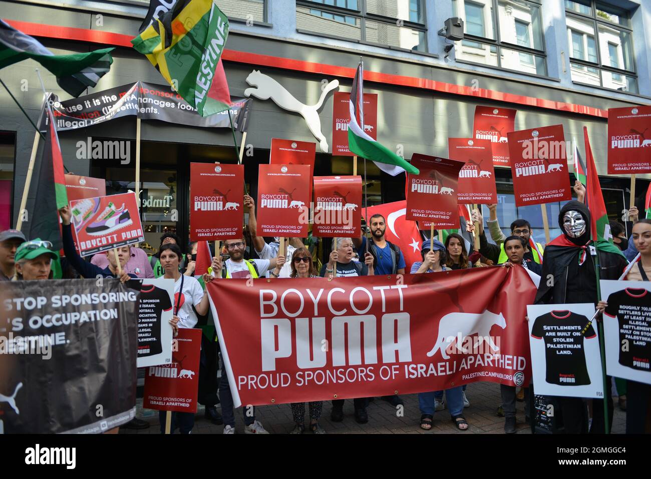 Protesters holding placards, banners and flags, during the demonstration.Boycott Puma protest organised by Palestine Solidarity Campaign and FOA (Friends of Al Aqsa) at Puma flagship store on Carnaby Street, London. Activists demonstrated against Puma's sponsorship of the IFA (Israel Football Association). (Photo by Thomas Krych / SOPA Images/Sipa USA) Stock Photo