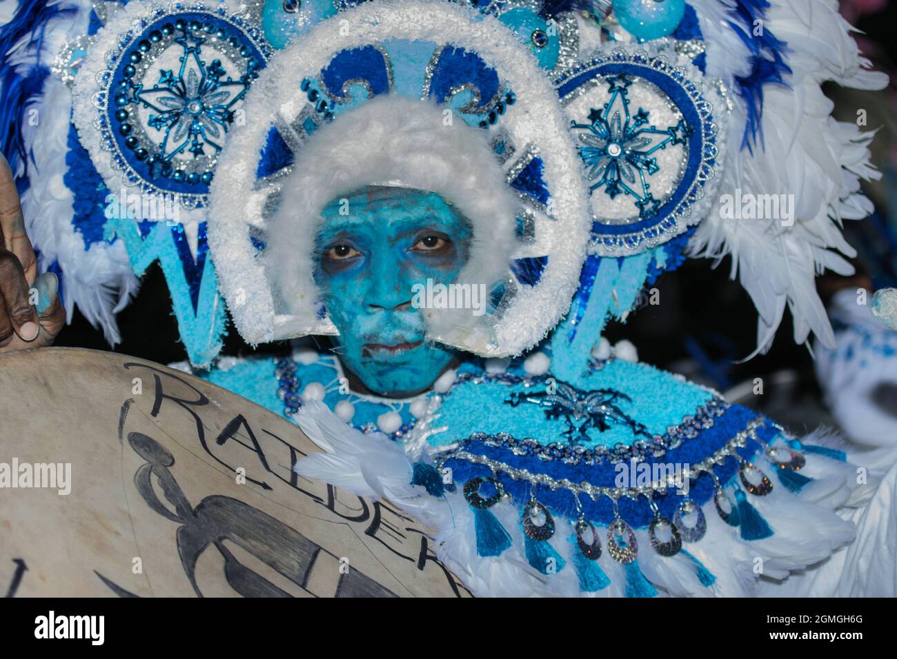 Man covered in blue paint as he celebrates Junkanoo, a street parade, rooted in the  African Slave tradition with in the Caribbean Stock Photo