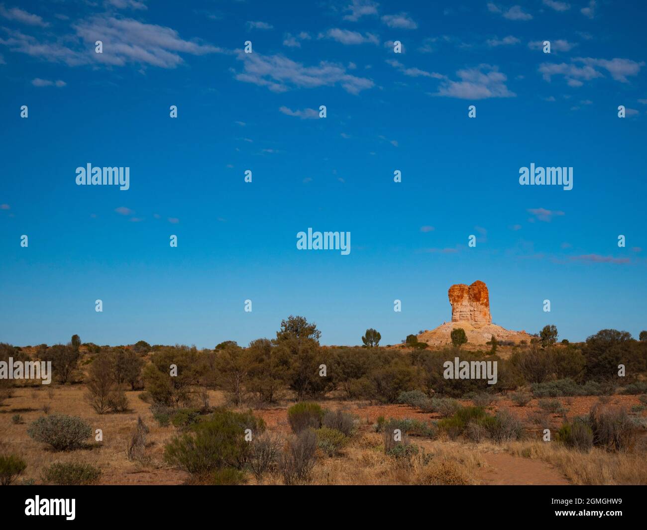 Chambers Pillar near Alice Springs rises out of the landscape in Central Australia. Stock Photo