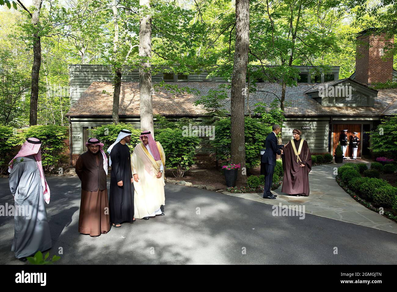 May 14, 2015'The President had hosted a summit meeting at Camp David with the Gulf Cooperation Council. At the conclusion of the summit, each of the leaders was introduced before a final group photo in front of Laurel Cabin. Rather than shoot a tight shot of each leader, I used a wide angle lens to show more of the atmosphere of Camp David. Here, the President greets Sayyid Fahd bin Mahmoud al Said, Deputy Prime Minister for the Council of Ministers’ Affairs of the Sultanate of Oman.' (Official White House Photo by Pete Souza) This official White House photograph is being made available only f Stock Photo