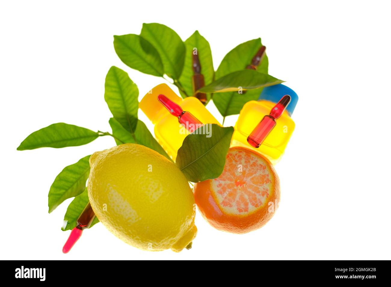 Vitamin C. Serum with vitamin C. Ampoules with a solution of vitamin C, tangerines and lemons with leaves, syringes Isolated on white background Stock Photo