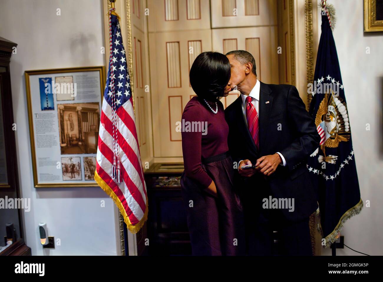 President Barack Obama kisses First Lady Michelle Obama in a holding room at the Capitol after delivering his first State of the Union address to a joint session of Congress, Jan. 27, 2010. (Official White House Photo by Pete Souza) This official White House photograph is being made available only for publication by news organizations and/or for personal use printing by the subject(s) of the photograph. The photograph may not be manipulated in any way and may not be used in commercial or political materials, advertisements, emails, products, promotions that in any way suggests approval or endo Stock Photo