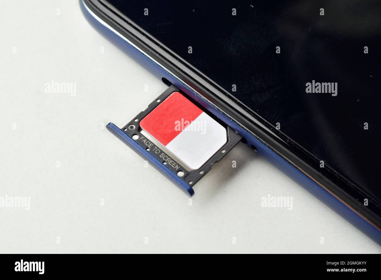 mini sim card with smartphone on white background Stock Photo - Alamy