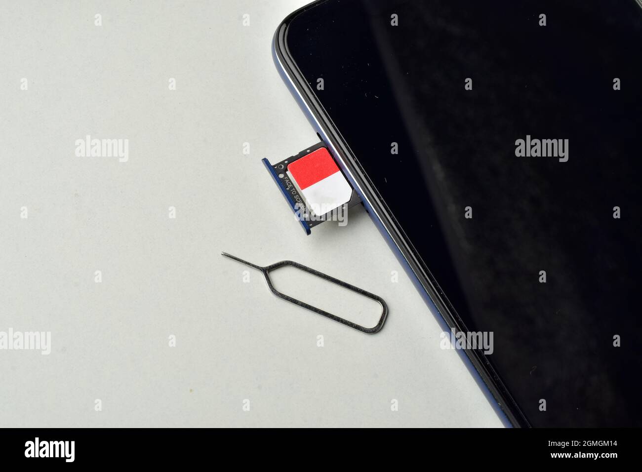 sim card with smartphone and ejector pin isolated on white background Stock Photo