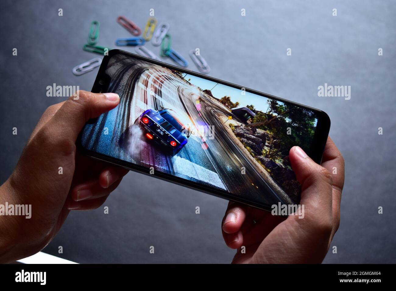 Playing Car Racing Game on Smartphone, Smartphone Gaming Stock Photo
