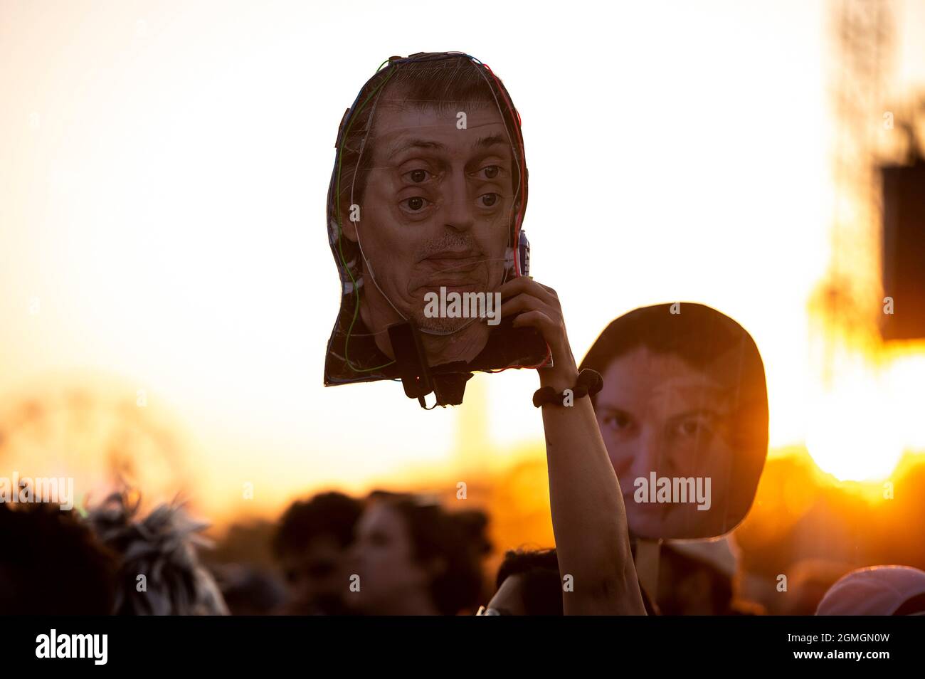 An attendee holds a picture of the actor Steve Buscemi while Vic