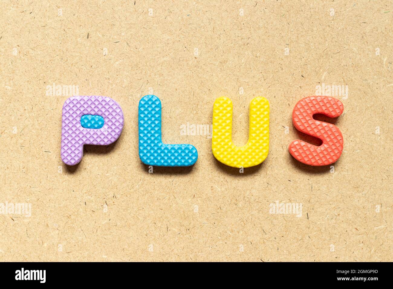 Foam alphabet letter in word plus on wood background Stock Photo Alamy