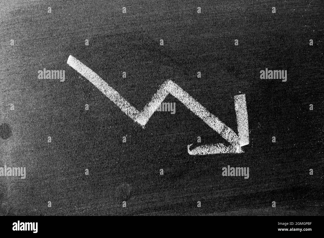 chalk board with sketch of decreasing business graph... White chalk hand drawing in arrow down shape on blackboard or ...