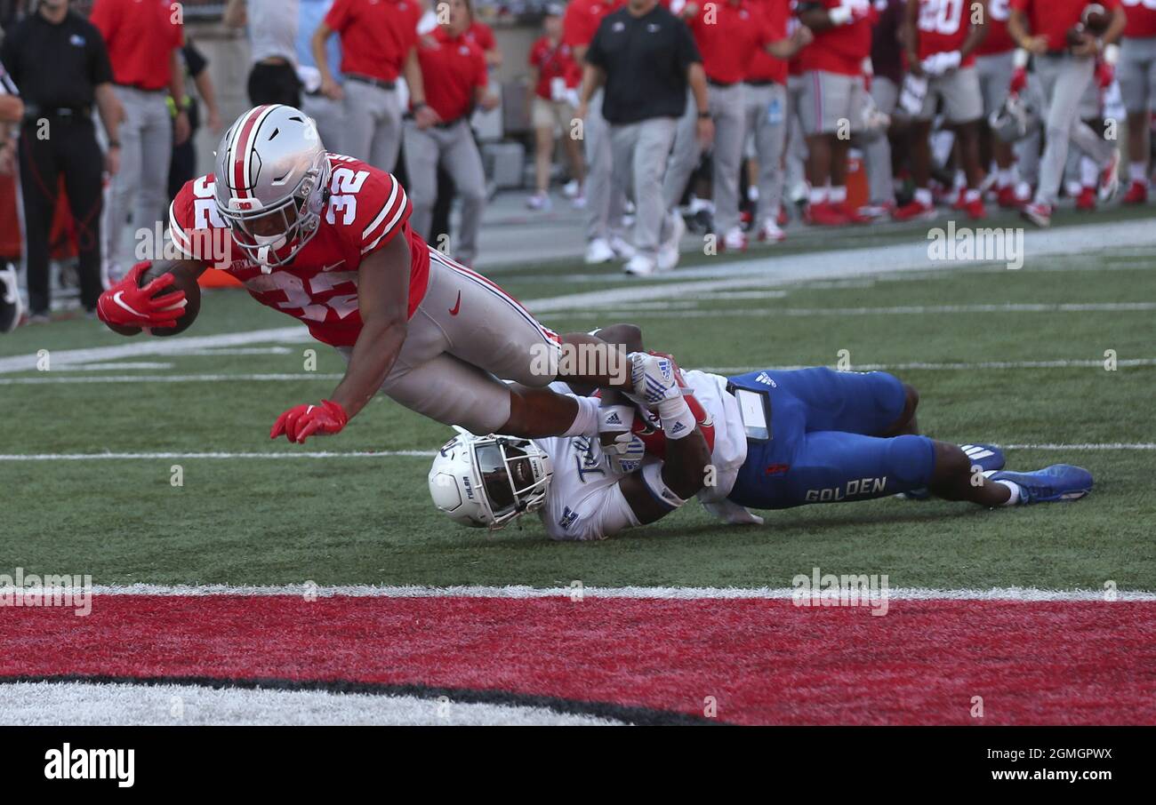 Columbus, United States. 18th Sep, 2021. Ohio State Buckeyes TreVeyon Henderson (32) dives into the endzone dragging Tulsa Golden Hurricane Tyon Davis (0) for a touchdown in the second half in Columbus, Ohio on Saturday, September 18, 2021. Photo by Aaron Josefczyk/UPI Credit: UPI/Alamy Live News Stock Photo