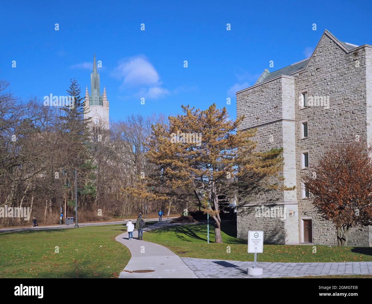 London, Ontario, Canada - December 4, 2018:  Students walking on the campus of Western University, towards the Middlesex College clock tower. Stock Photo