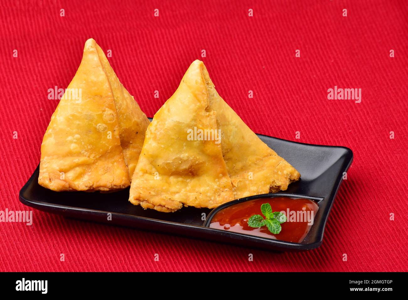 Stuffed Samosas with Ketchup in Plate, Tasty Asian Snack Samosa Stock Photo