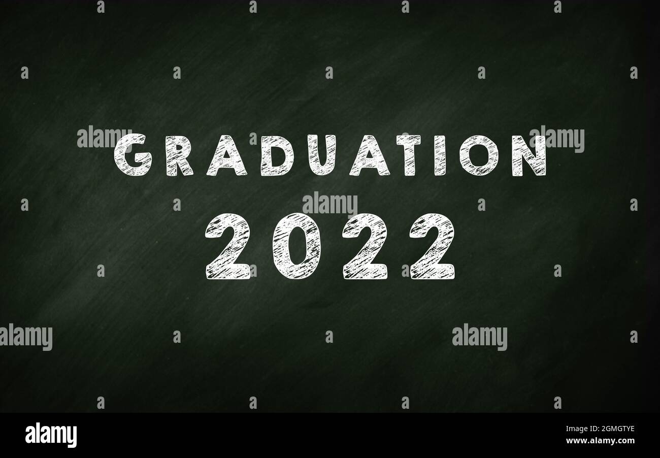 Graduation 2022 Chalkboard . Lettering On a School green Chalk Board. Students graduation in 2022 concept hand Stock Photo
