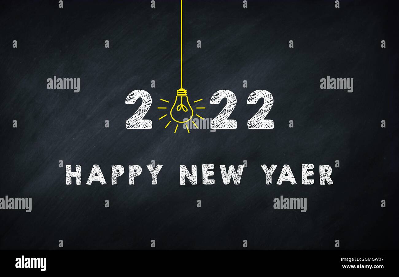 Happy New Year 2022 chalkboard Creative Concept. 2022 Light Bulb On Blackboard. Stock Photo