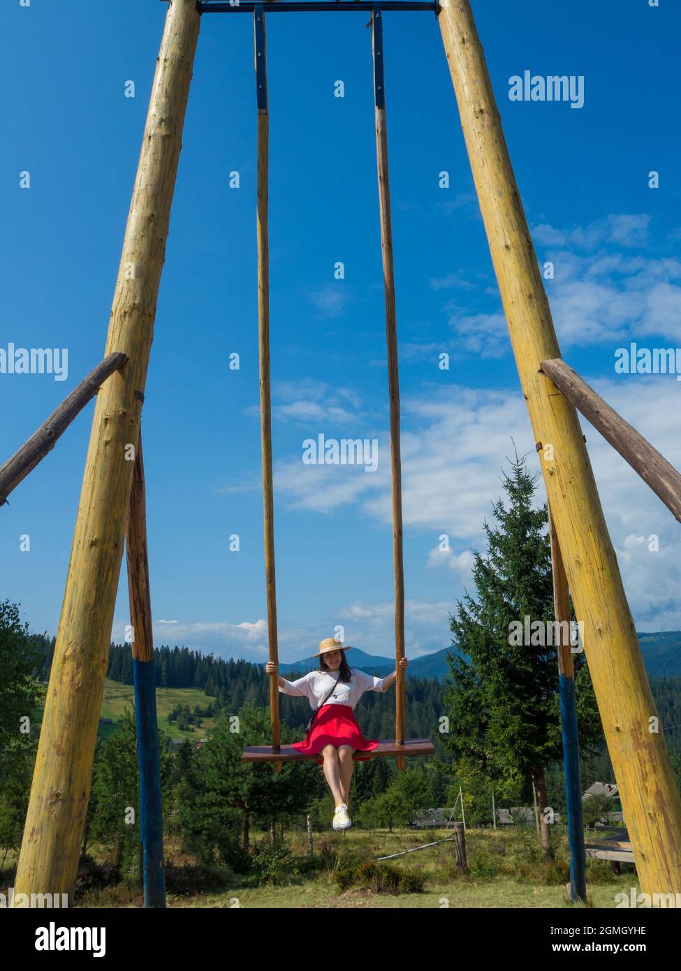 woman traveler enjoying of swinging on heavenly swing and mountain view ...