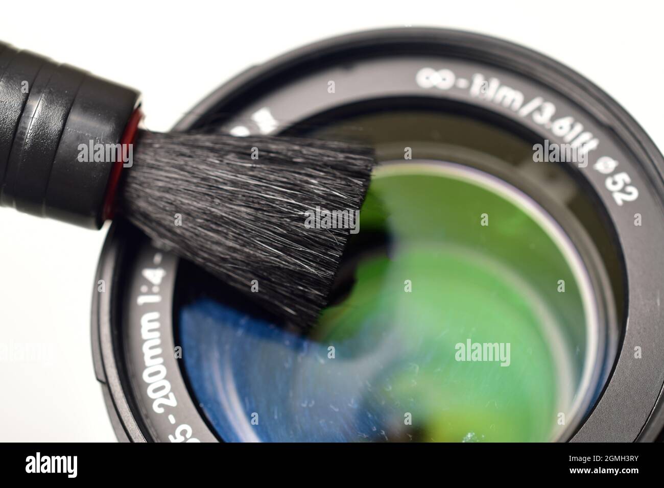 Removing dust from lens, Cleaning Camera Lens with Brush Stock Photo