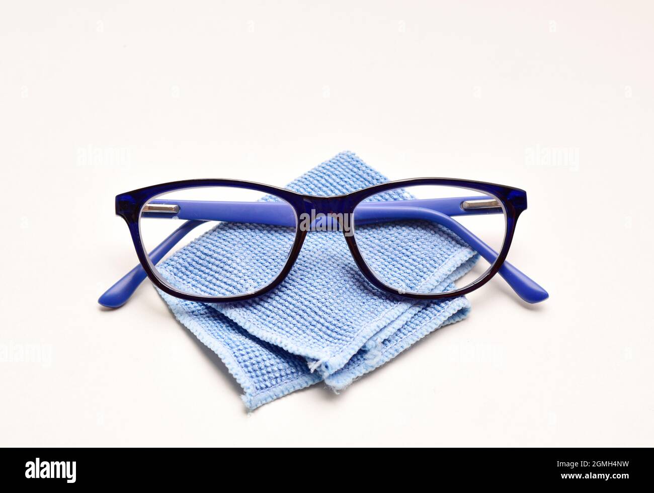 Eyewear with soft microfiber cloth over white background, spectacle and cloth Stock Photo
