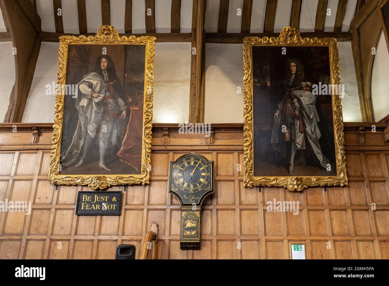 Interior of the Guildhall in Guildford, Surrey, England, UK. The Tudor ground floor with wood panelling, historic portrait paintings and clock. Stock Photo