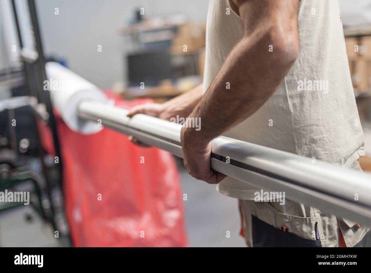 Technician worker operator changes the paper roll on large premium