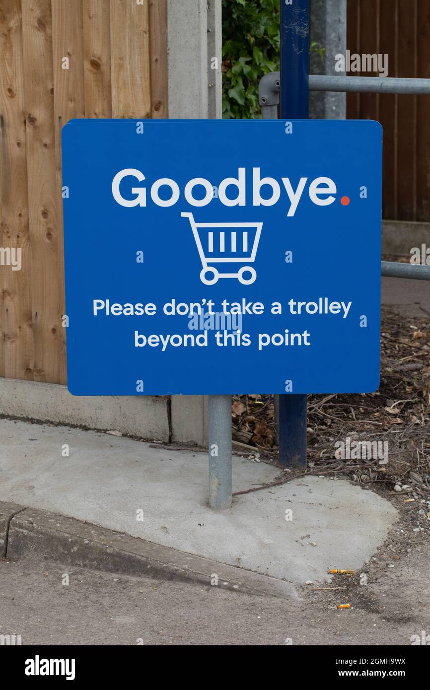 Sign, supermarket request, asking customers not to take trolley beyond this point, ie beyond or out of car park. Stock Photo