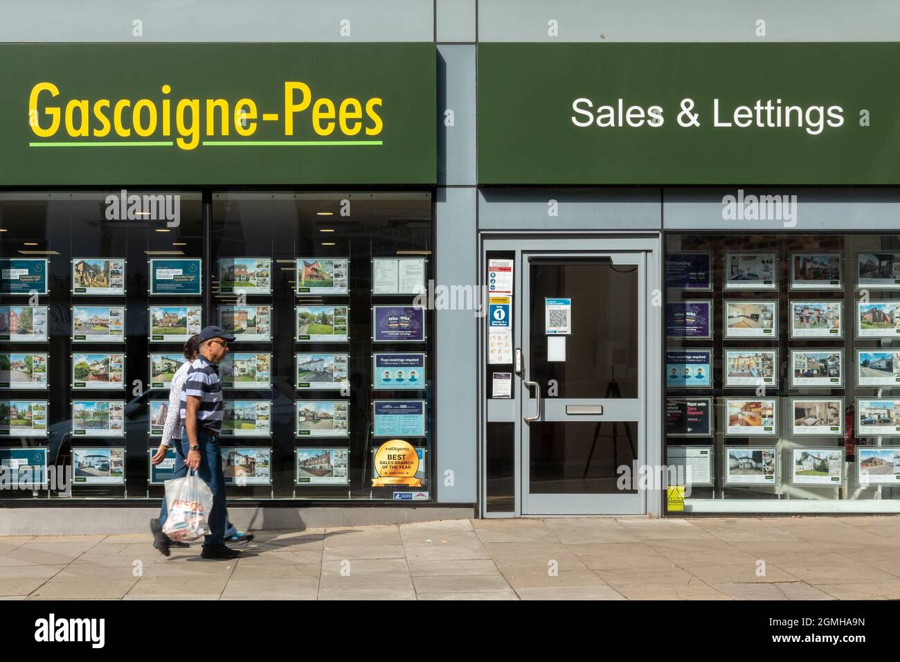 Branch of Gascoigne-Pees estate agent with people walking past, sales and lettings agency on the high street, UK Stock Photo
