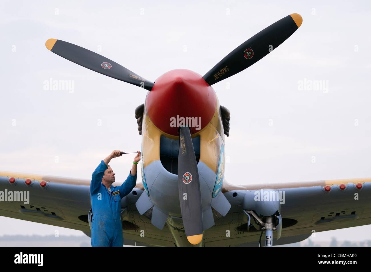 Ground crew carry out checks on a Grumman Wildcat on the flightline during the Battle of Britain Air Show at IWM Duxford. Picture date: Sunday September 19, 2021. Stock Photo