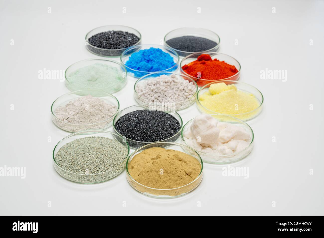 Examples of dry bulk chemical elements in petri dishes on a white