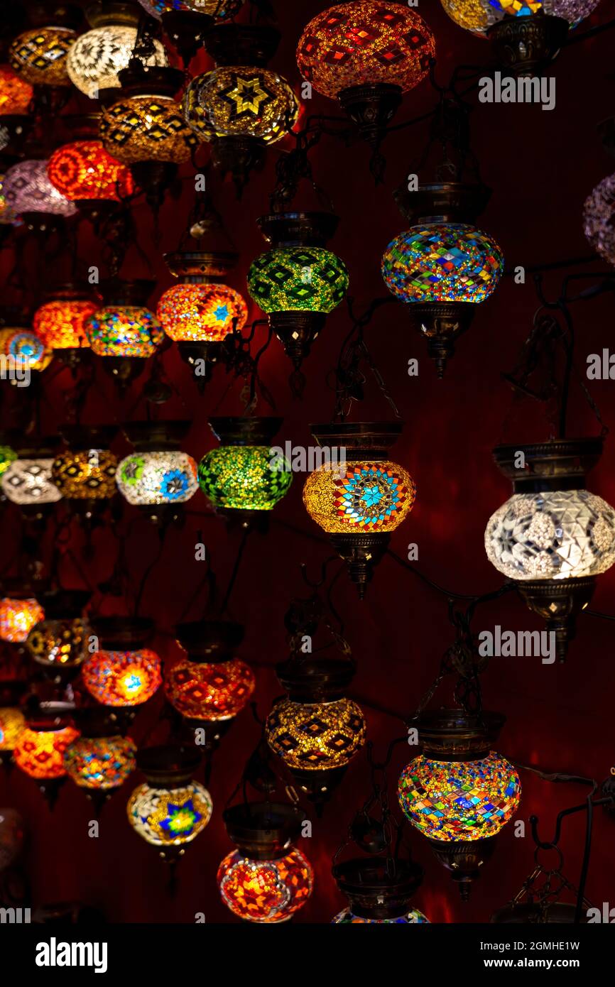 Selective focus of Oriental lantern in row with different mosaic art and colors. Stock Photo