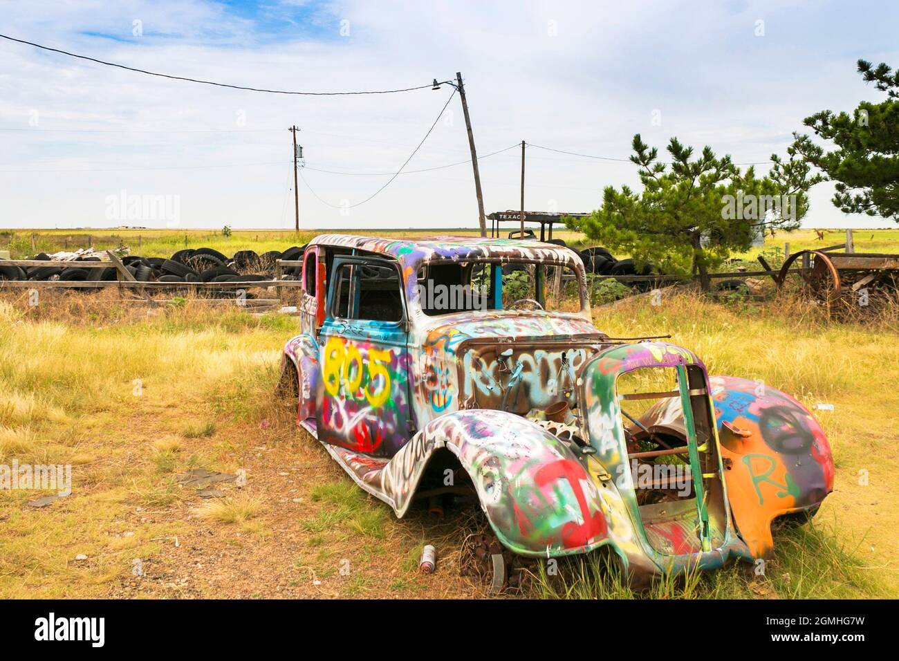 old spray painted graffiti covered vintage car at VW Slug
