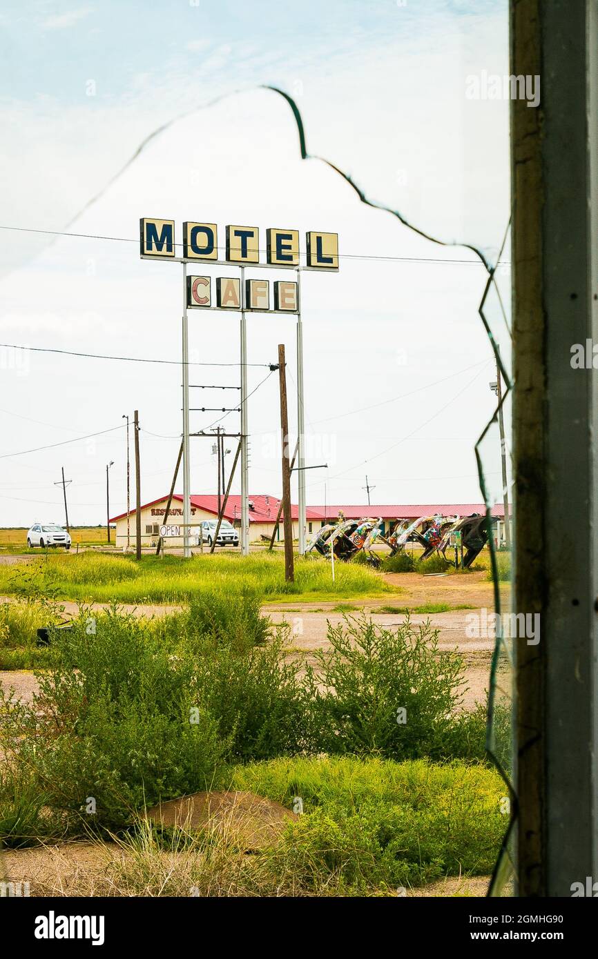 painted Volkswagen Beetles half buried at an angle at Slug Bug Ranch