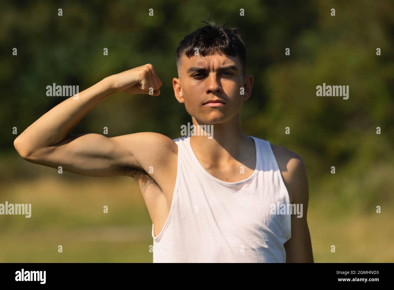 Teenage Boy Flexing Muscles Stock Photo - Download Image Now - Muscular  Build, Swimming Pool, Teenage Boys - iStock