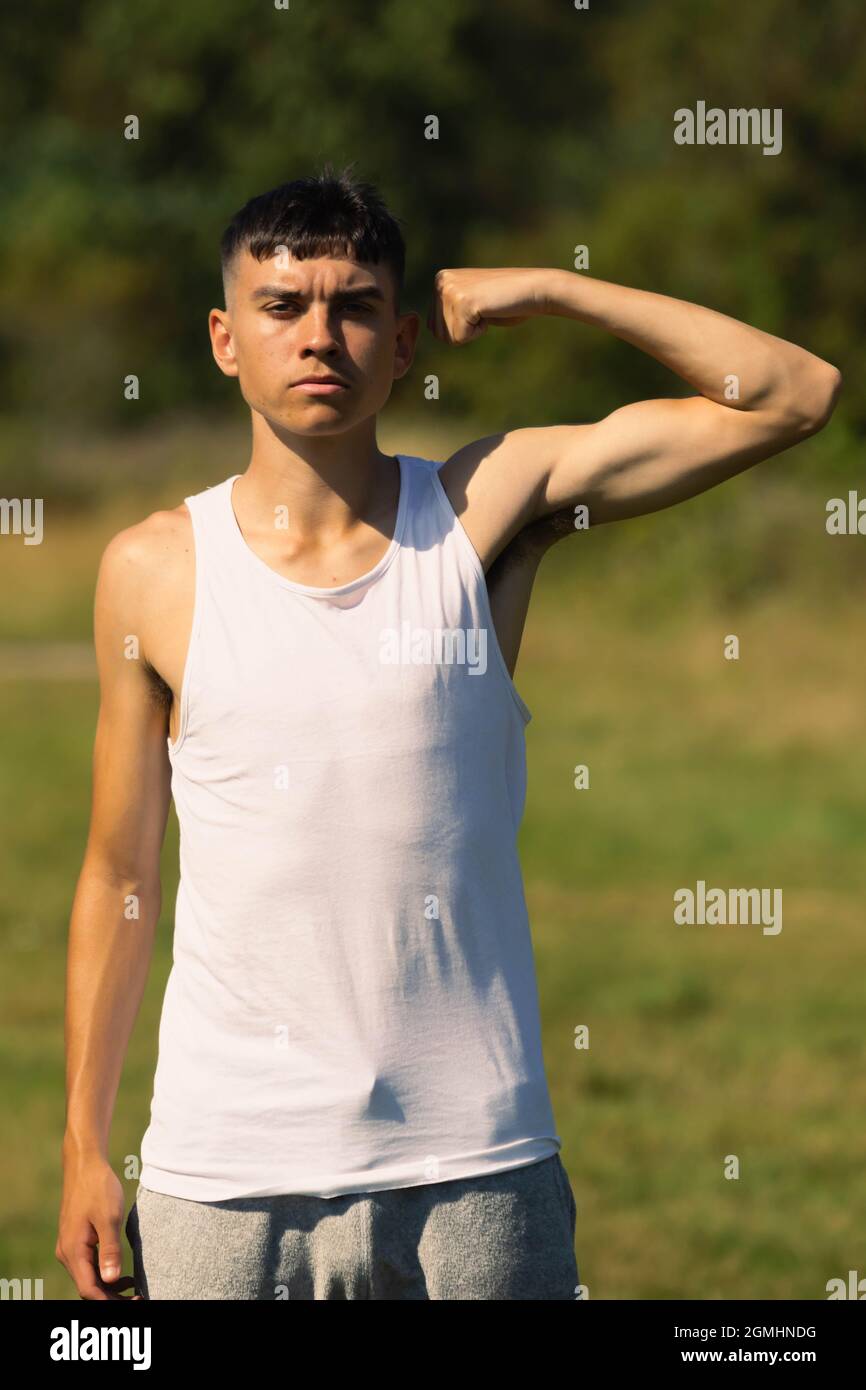 Teen boy flexing arm hires stock photography and images Alamy