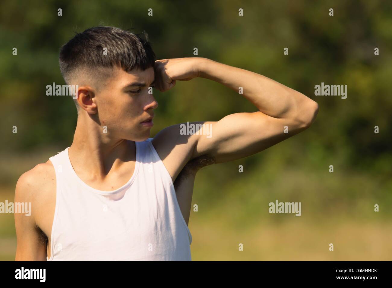Teenage Boy Flexing Muscles Stock Photo - Download Image Now - Muscular  Build, Swimming Pool, Teenage Boys - iStock