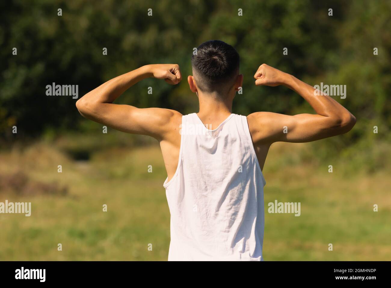 Teen boy flexing arm hires stock photography and images Alamy
