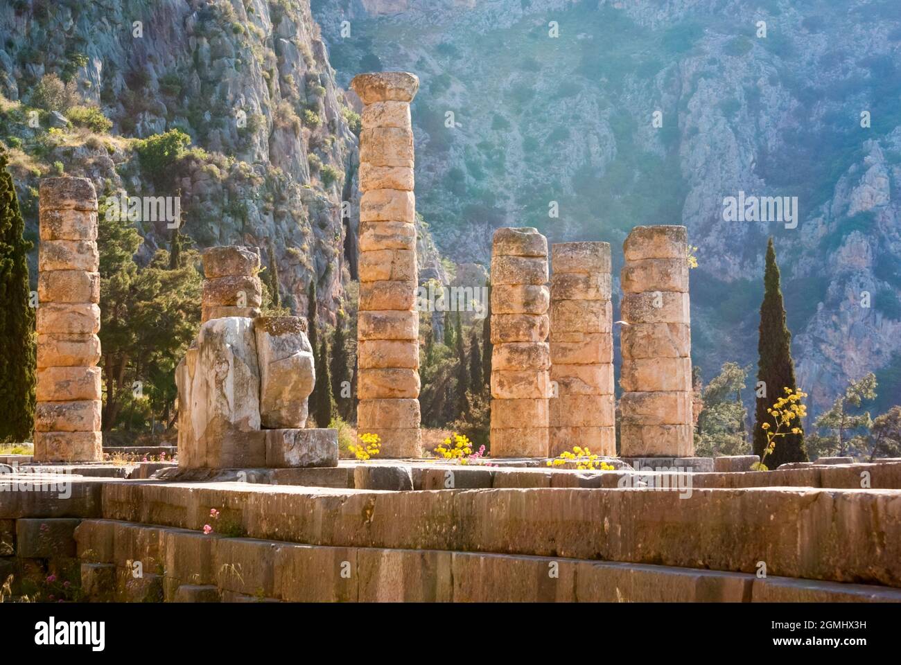 Greek Temple Between Rocks Ruins and columns of an ancient greek temple in front of rocks and ...