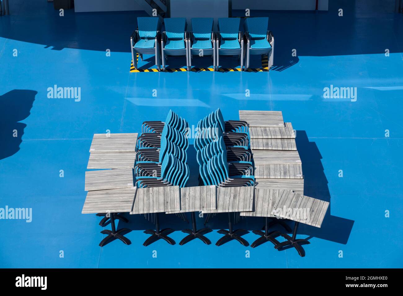 stacked chairs and tables on a ship of the cruise company Koeln-Duesseldorfer Deutsche Rheinschiffahrt AG, Cologne, Germany.  gestapelte Stuehle und T Stock Photo