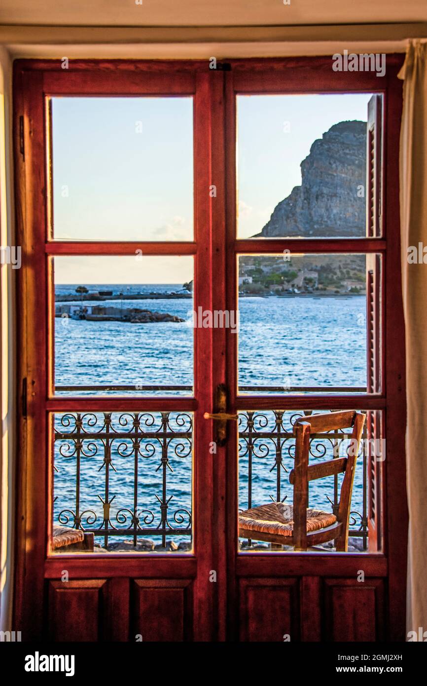 Window and balcony with view on the blue sea and the sightseeing place under the afternoon sunlight Stock Photo