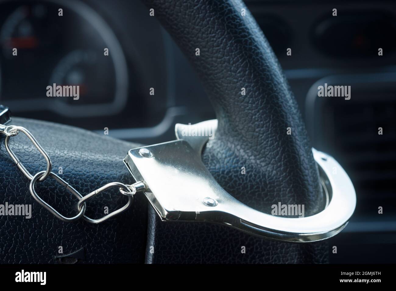 handcuffs hanging on the steering wheel of the car. High quality photo Stock Photo