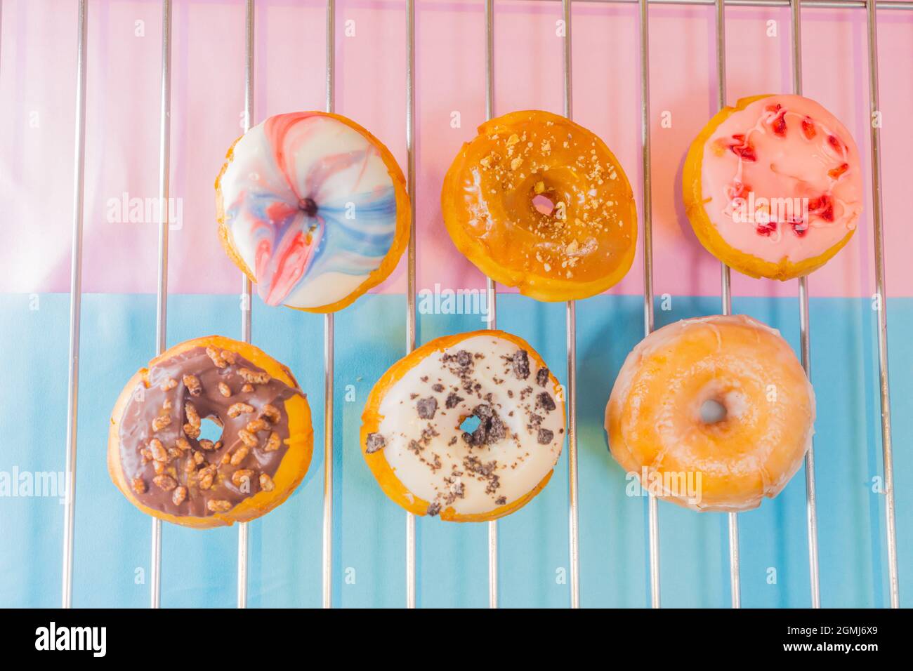 A top view of colorful tasty doughnuts on a metal net Stock Photo - Alamy