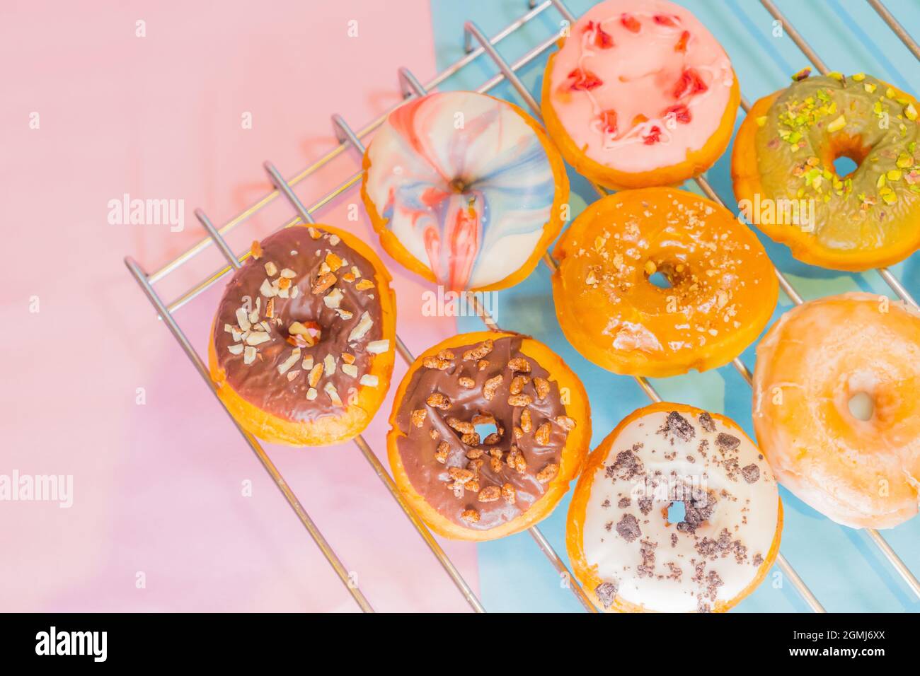 A top view of colorful tasty doughnuts on a metal net Stock Photo - Alamy