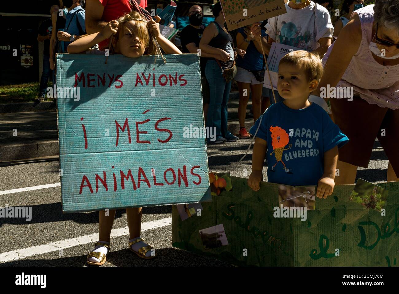 Barcelona, Spain. 19th Sep, 2021. A small girl with a placard reading 'less planes, more animals' takes part in a protest against an originally planned expansion of the 'El Prat' airport's runway affecting a nearby natural area called 'La Ricarda'. The expansion plan has been put on hold already due to differences between the Spanish and Catalan regional governments. Credit: Matthias Oesterle/Alamy Live News Stock Photo