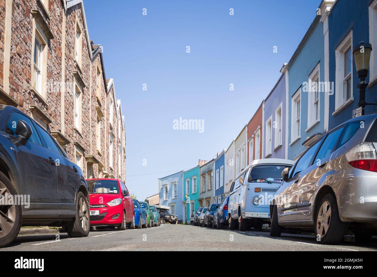 Typical street of Victorian terraced houses in the Cliftonwood neighbourhood of Bristol, UK, emphasising on-street parking. Stock Photo