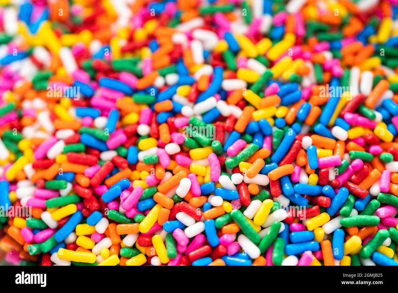 Mixing ingredients to bake birthday funfetti cake with colorful