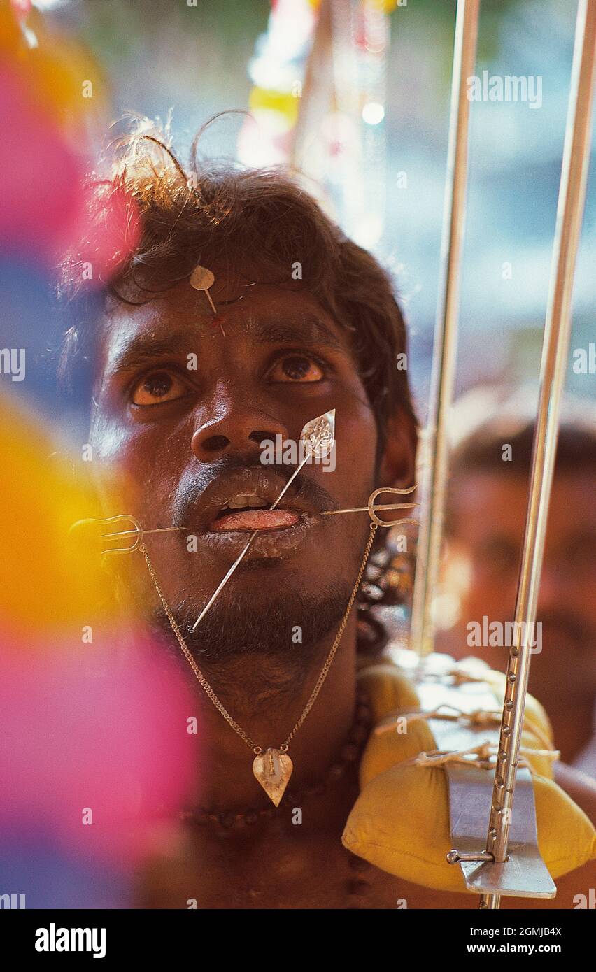 Singapore. Thaipusam Religious festival. Close up of man with skewers through his face. Stock Photo